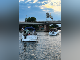 A scenic view of two boats cruising on a river in Washington, DC, with a group of people enjoying the ride — perfect for summer outings and water adventures.