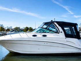 A sleek speedboat docked at the marina, showcasing its elegant design against a clear blue sky — perfect for leisurely outings on the water.