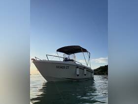 A stunning view of a boat anchored in calm waters, showcasing its sleek design against a clear sky — perfect for a day out on the water.