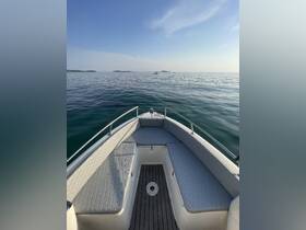 A serene view from the front of a boat, showcasing the sleek design and calm waters ahead, perfect for a day of exploration on the open sea.