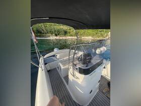 A view of the helm area inside a boat, showcasing the console and seating arrangements, perfect for navigating the waters in comfort.