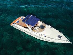 Aerial view of a sleek speedboat gliding over crystal-clear waters, showcasing its elegant design and perfect for thrilling adventures on the sea.