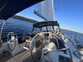An interior view of a sailboat's helm and console, showcasing the sleek design and functionality, perfect for navigating the open waters.
