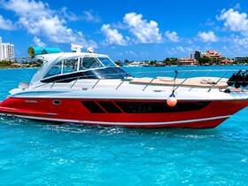 A striking Doral yacht glides through crystal-clear turquoise waters, showcasing its sleek design against a vibrant coastal backdrop.