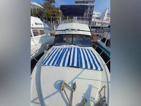 A clear view of a yacht docked with a striped cover on the deck, showcasing its sleek design and inviting atmosphere.