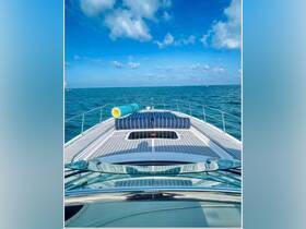 A stunning view from the front of a yacht, showcasing the sleek deck and vibrant blue waters under a clear sky — perfect for luxury cruising.