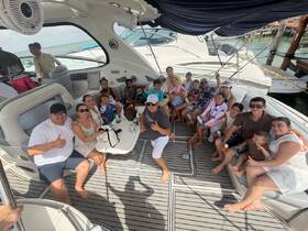 A joyful group of family and friends gathers on a boat, enjoying their time together — perfect for celebrations and memorable outings on the water.
