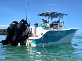 A family enjoys a day on the water aboard a fishing boat, showcasing the perfect blend of adventure and relaxation in a beautiful setting.