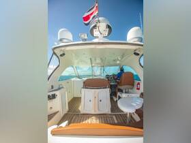 The interior helm of a boat showcases comfortable seating and modern controls, perfect for navigating the open waters.