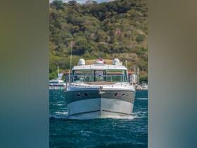 A striking view of a yacht cruising through clear waters, showcasing its elegant design and vibrant surroundings.