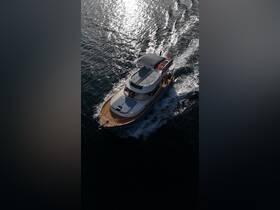 A stunning aerial view of a yacht cruising through shimmering waters, showcasing its elegant design and smooth sailing.