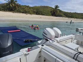 A fun day at the beach with friends enjoying the water on floating mats — perfect for relaxation and family bonding in a tropical paradise.