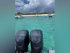 A vibrant scene featuring multiple boats anchored near a beautiful beach, with people enjoying the clear turquoise waters — perfect for a day of relaxation and fun in the sun.