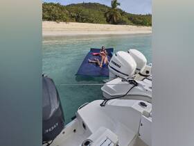 Two individuals enjoy a relaxing day on a floating mat in crystal-clear waters, perfect for family fun and beach outings.