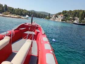 Interior view of a sleek red boat showcasing comfortable seating and helm, perfect for enjoying a day on the water.