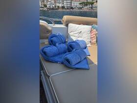 A cozy setup featuring neatly rolled blue towels on a boat, perfect for a relaxing day on the water. Ideal for guests looking to enjoy sunbathing or swimming.
