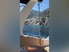 A stunning view from a boat showcasing the picturesque Amalfi Coast, with colorful buildings nestled against the mountains — a perfect backdrop for a memorable boating experience.