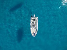 Aerial view of a boat cruising through crystal-clear waters, showcasing a perfect day on the water with friends.