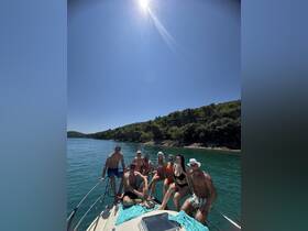 A lively group enjoys a sunny day on a boat, showcasing the perfect setting for summer fun and relaxation on the water.