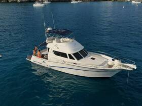 A group of friends enjoys a day on the water aboard a Rodman 1250, showcasing the perfect blend of relaxation and adventure.