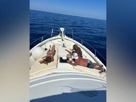 A group enjoys a relaxing day on the boat, sunbathing and taking in the serene ocean views — perfect for a day of leisure on the water.