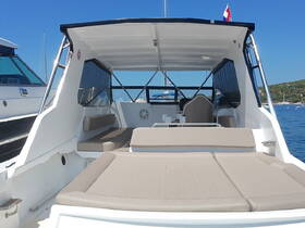 Interior view of a spacious boat cabin featuring comfortable seating, perfect for relaxing while enjoying the scenic waters.