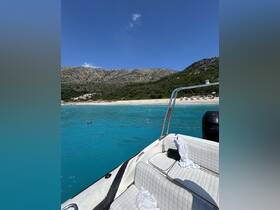 A scenic view from a boat showcasing the stunning turquoise waters and beach, perfect for snorkeling adventures and relaxing days on the water.