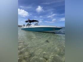 A sleek speedboat rests in shallow waters, showcasing its vibrant design against a clear blue sky — perfect for thrilling water adventures.