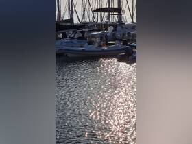 A serene view of boats docked at a marina, showcasing the tranquil waters and reflections of sunlight — perfect for boat enthusiasts and marina lovers.
