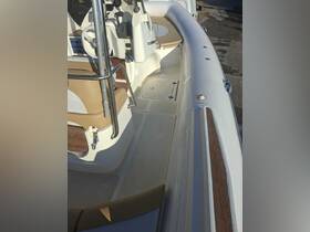 An interior view of a boat's helm and seating area, showcasing the modern design and comfortable layout, ideal for a day on the water.