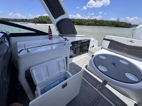 An inviting interior view of a modern boat showcasing the helm and seating area, perfect for relaxing and enjoying the water.