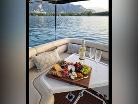A beautifully arranged charcuterie board featuring a selection of cheeses, meats, and fruits, complemented by a bottle of white wine — perfect for a relaxing day on the water.
