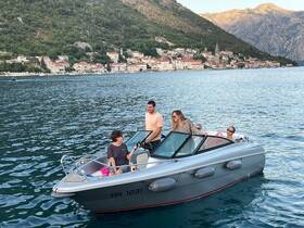 A lively group enjoys a boat ride along the stunning coastline, creating unforgettable memories on the water.