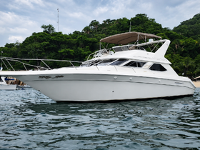 A sleek yacht is docked in calm waters, showcasing its elegant design against a lush green backdrop — perfect for luxury charters and coastal adventures.