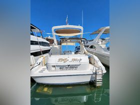 A clear view of the 'Why Not?' boat docked in Puerto Vallarta, showcasing its sleek design against a vibrant blue sky.