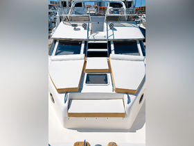 A clean and spacious view of the helm area on a boat, showcasing comfortable seating and a well-designed layout, perfect for relaxing while cruising.