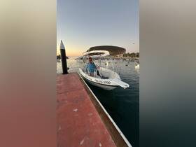 A speedboat named 'FEELING GOOD' docked at sunset, showcasing a serene marina setting perfect for a relaxing day on the water.