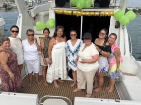 A joyful group celebrates a birthday aboard a boat, showcasing a festive atmosphere with decorations and smiles, perfect for memorable gatherings on the water.