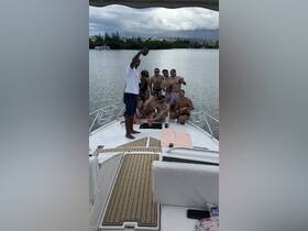 A lively group of friends enjoys a fun day on the boat, capturing memories with drinks in hand — perfect for celebrations and summer outings.