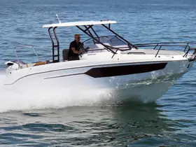 A sleek speedboat in motion on clear waters, showcasing its modern design and performance capabilities.