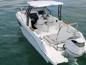 A sleek center console boat captured in clear waters, showcasing its modern design and spacious layout, perfect for fishing or leisure outings.