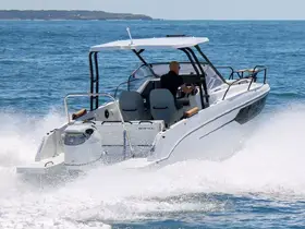 A speedboat navigates through the waves with a captain at the helm, showcasing the thrill of boating on open waters.