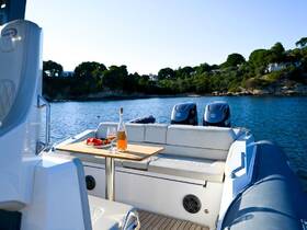 A beautifully set table on a boat featuring a bottle of rosé and fresh strawberries, perfect for a relaxing day on the water.