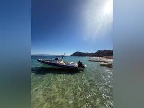 A sleek speedboat anchored in crystal-clear waters, showcasing a perfect day at the beach — ideal for summer adventures and water sports.