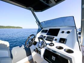 A sleek view of the helm and console area inside a modern boat, showcasing the advanced navigation equipment and stylish design, perfect for a day on the water.
