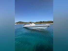 A sleek speedboat glides through crystal-clear waters, showcasing its elegant design against a picturesque backdrop of lush greenery.