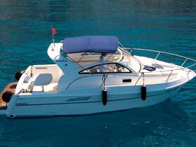 A sleek yacht named 'ALTAR 8' glides through crystal-clear waters, showcasing its elegant design and inviting atmosphere for a perfect day on the water.