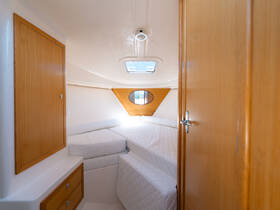 A cozy cabin interior featuring twin beds and wooden accents, perfect for relaxing on a boat trip.