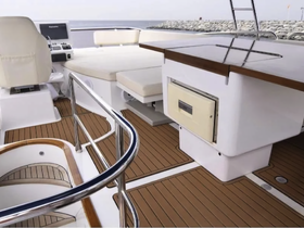 A well-designed interior of a boat showcasing the helm and seating area, perfect for comfortable navigation and relaxation on the water.