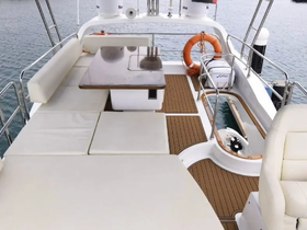 A spacious and elegantly designed interior of a boat featuring comfortable seating and a dining area, perfect for relaxing while cruising on the water.